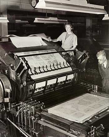 Photo of woman and man at a printing machine