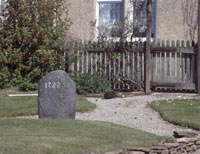Photo of a small standing stone in a garden