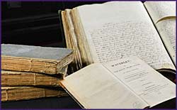 Photo of a manuscript and books