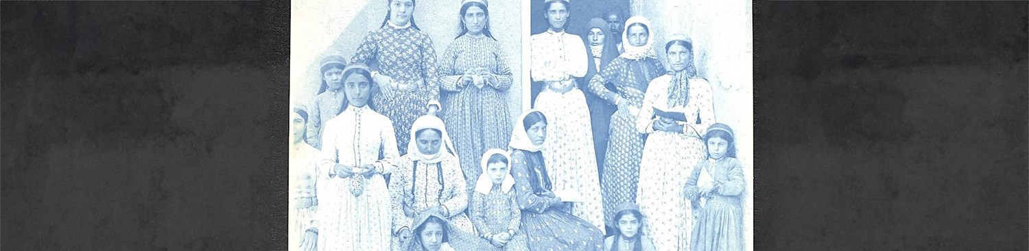 Old black and white photograph of a group of female school students and teachers sitting and standing in front of a building in Julfa, Southern Arabia