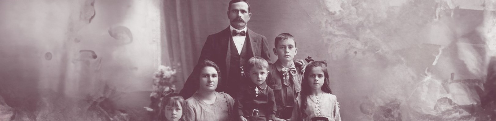 An old black and white photo of a family.
