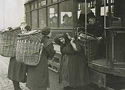 A black and white photo of fish wives getting on (or off) a tram.