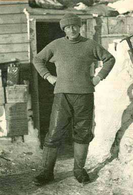 Wilson standing outside expedition hut