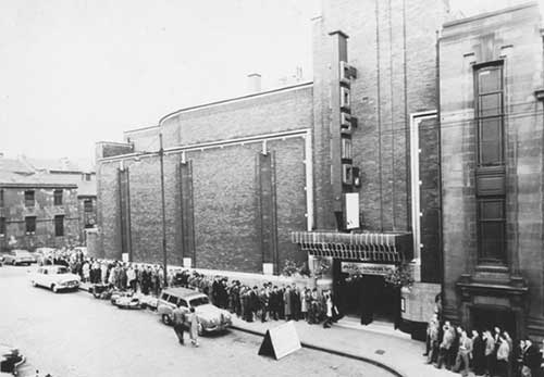 Photo of people queuing outside a cinema