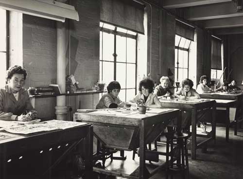 Photo of women seated at tables