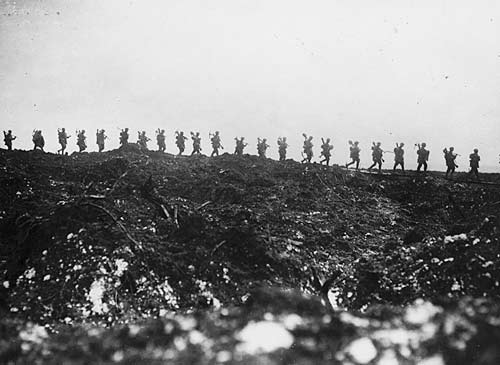Row of soldiers on hill carrying picks and shovels