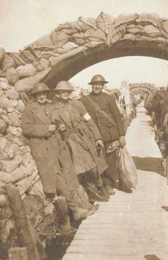 Two nurses and a soldier in a trench