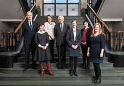 Group of 7 men and women on staircase