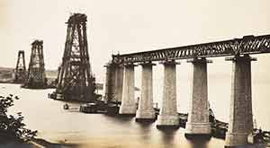 Photo of the Forth Bridge cantilevers under construction