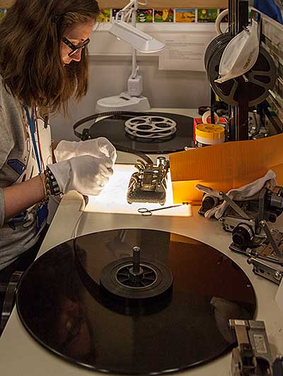 Woman inspecting film over a lightbox