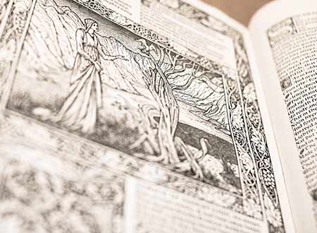 Open book with ornate illustration of a woman