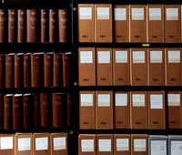 Photo of shelves with books and boxes