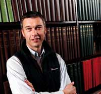 Photo of man in front of shelving