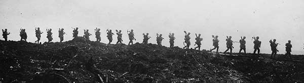 Silhouetted row of soldiers with shovels