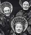 Three women wearing large bonnets