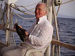 Man on boat polishing shoes
