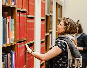 Woman at bookshelves