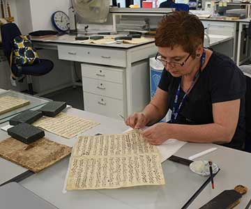 Conservator working on manuscript