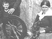 Woman sitting at spinning wheel