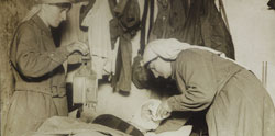 Nurses attending wounded solider at first-aid post