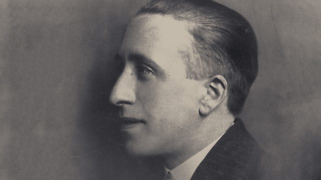 Black and white photo of a man in profile with slicked back hair.