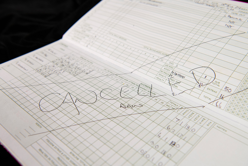 A cricket score book with a big cancelled due to rain notice.