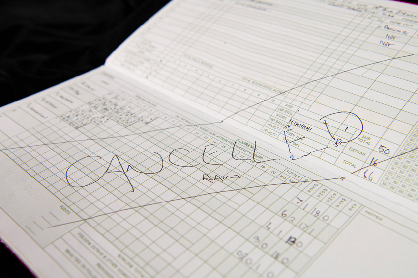 A cricket score book with a big cancelled due to rain notice.