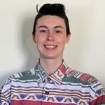 A person wearing a colorful shirt featuring decorated with geometric patterns.