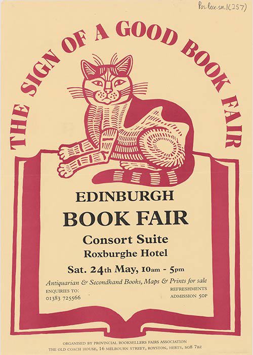 A cat sits under the words 'The sign of a good book fair'. 