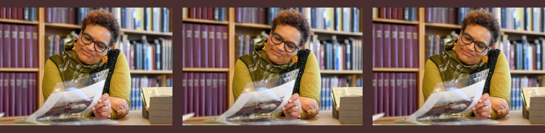 Jackie Kay sitting looking at her archives.
