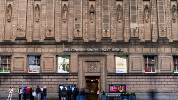 The building exterior at the entrance of the National Library of Scotland with people outside