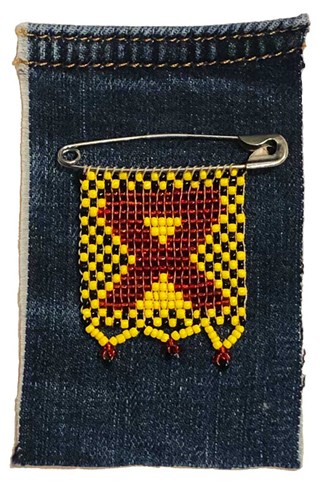 A beaded ribbon motif on a piece of denim