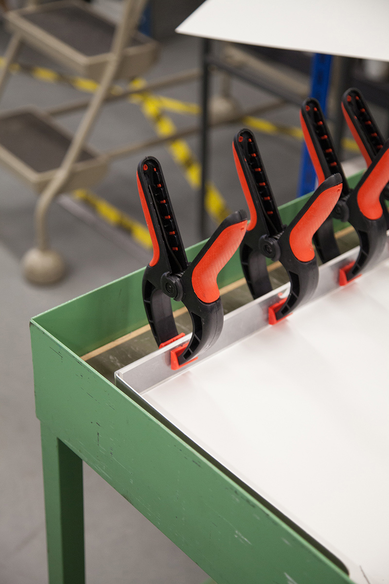 Three clips pressing cardboard together.