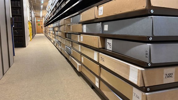 Boxes on shelves down a long corridor.