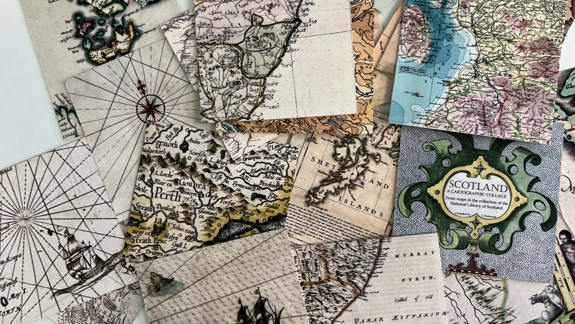 Pieces of a maps jigsaw spread out on a table.