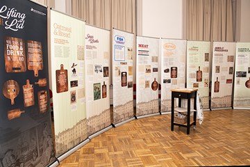 Nine panels for the touring display Lifting the Lid displayed in a semi circle.