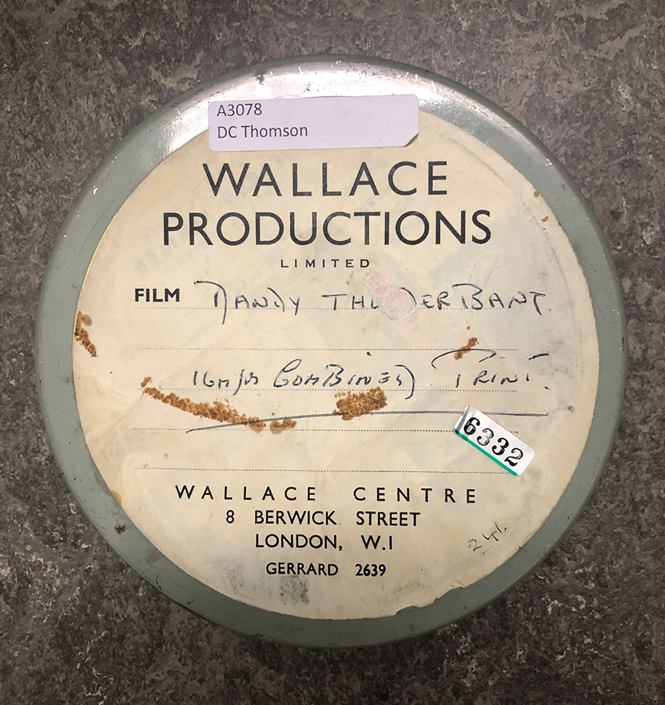 A round film can with a label that says "The Dandy Thunderbang" on it.