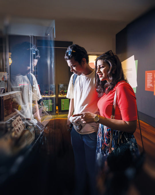 Two people visiting a Library exhibition.