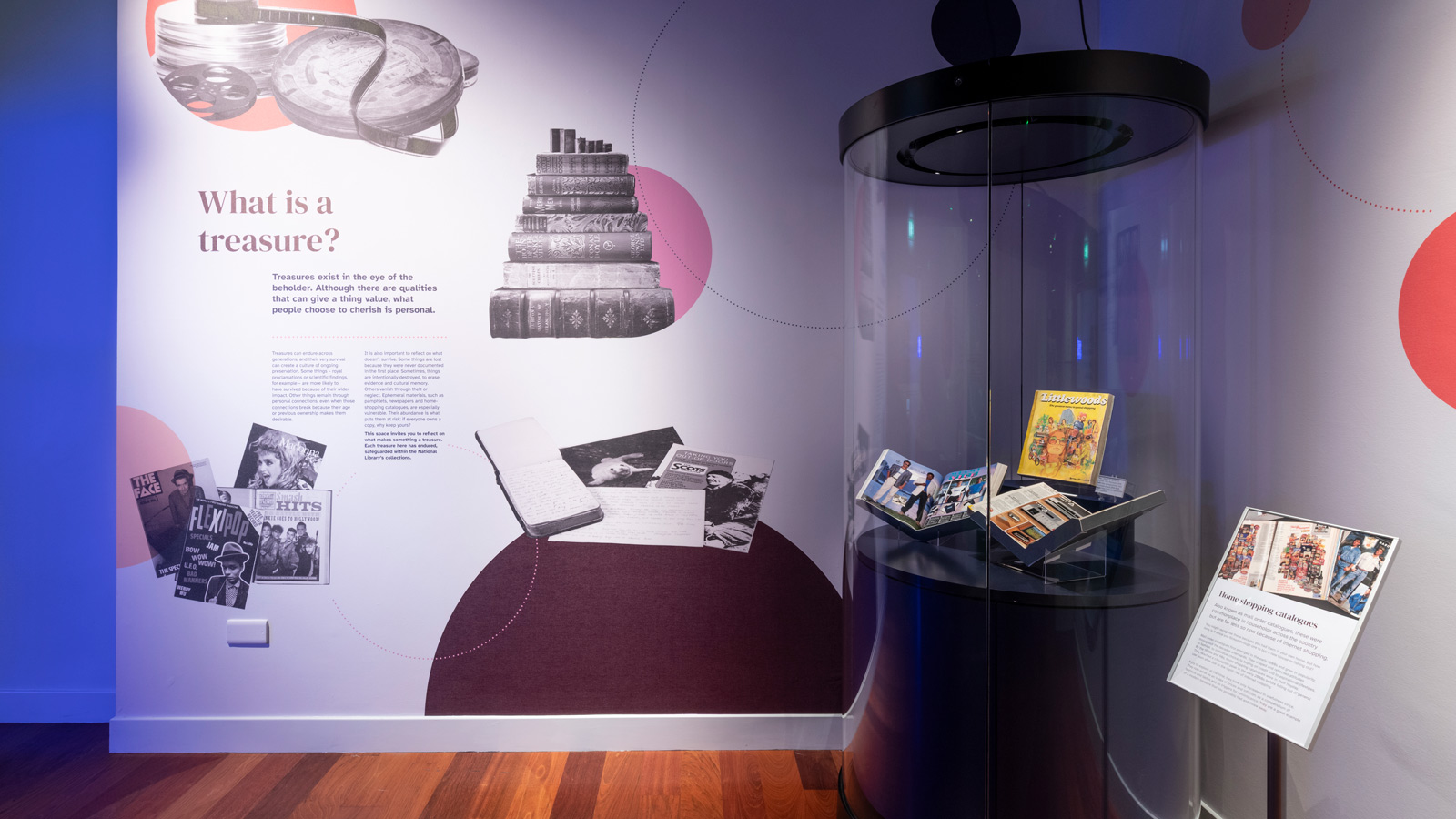 An exhibition panel describing what a treasure is and a round exhibition case next to it showing home shopping catalogues.