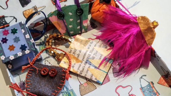 Several hand-made items arranged in a book box.