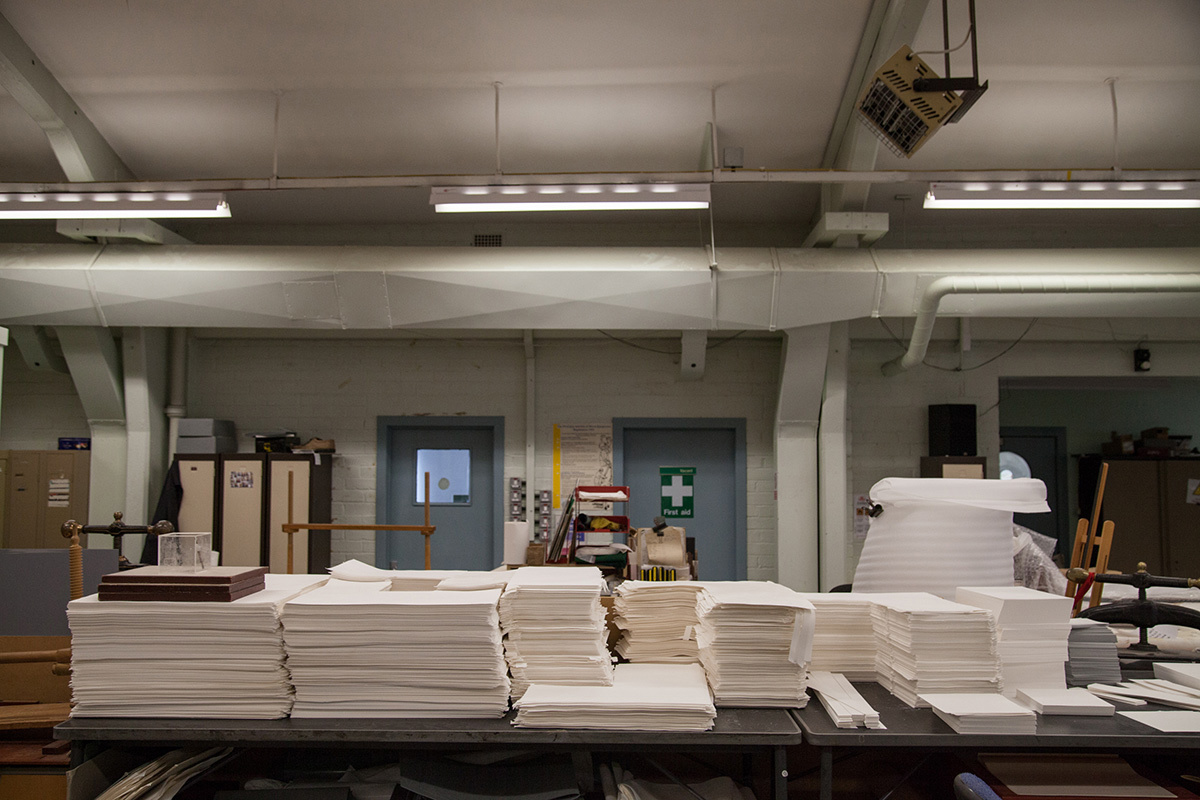Stacks of white card in various sizes sitting on a table.