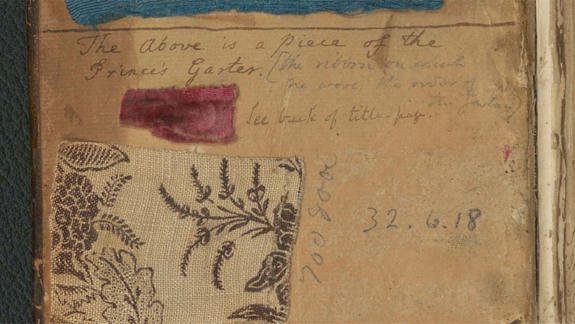 Page from an old book with three fabric swatches—blue, red, and beige with black floral pattern, labelled as part of Prince Charles Edward Stuart’s garter ribbon.