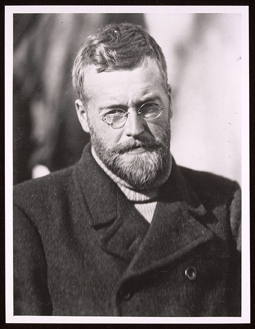 Black and white portrait of a man wearing glasses.