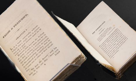 Two open books showing the first pages of 'Pride and Prejudice' by Jane Austen and 'The Inheritance' by Susan Ferrier.