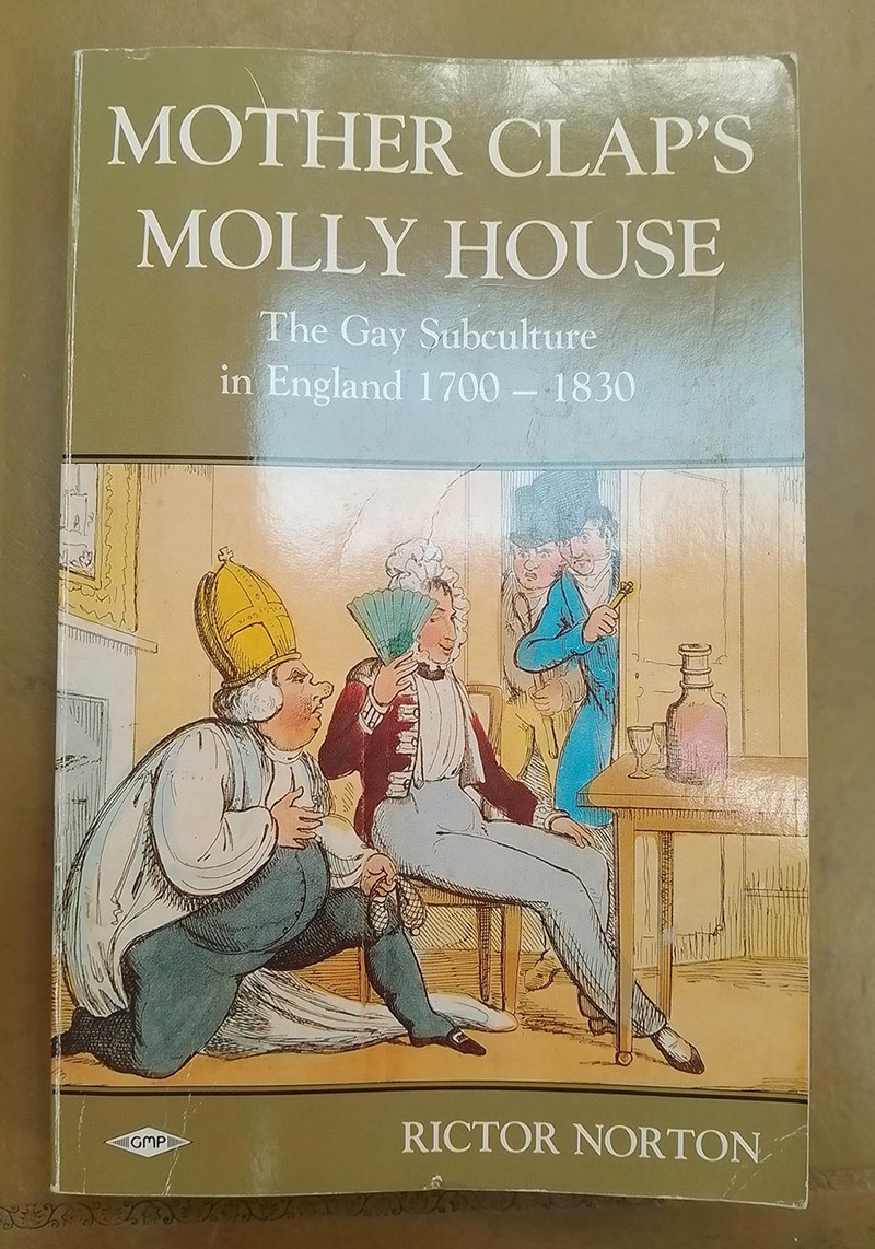 Book cover of 'Mother Clap's Molly House: The Gay Subculture in England 1700–1830' by Rictor Norton. The illustration shows three figures in 18th-century attire: one seated and holding a fan, with another kneeling beside him. Two others are squeezing through the door into the room.