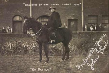 A black and white photo of a man sitting on a horse. Text reads "Souvenir of the Great Strike 1926", "On patrol", "Fraternally Yours, John Bird".