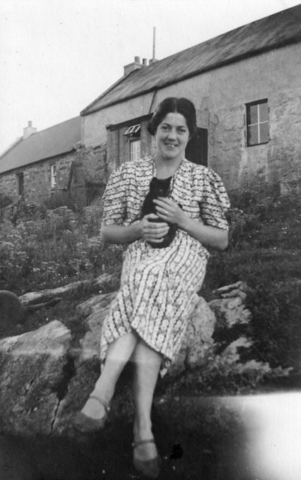 Valda Trevlyn sitting in a garden holding a kitten.