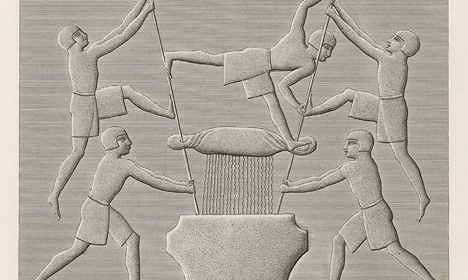 Engraved relief showing five human figures using long poles around a large vessel, with one figure balancing horizontally above the container.