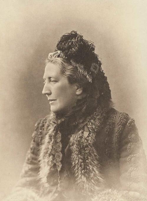 Portrait of a woman wearing a fur lined jacket and a head piece