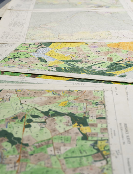 Maps spread out on a table.
